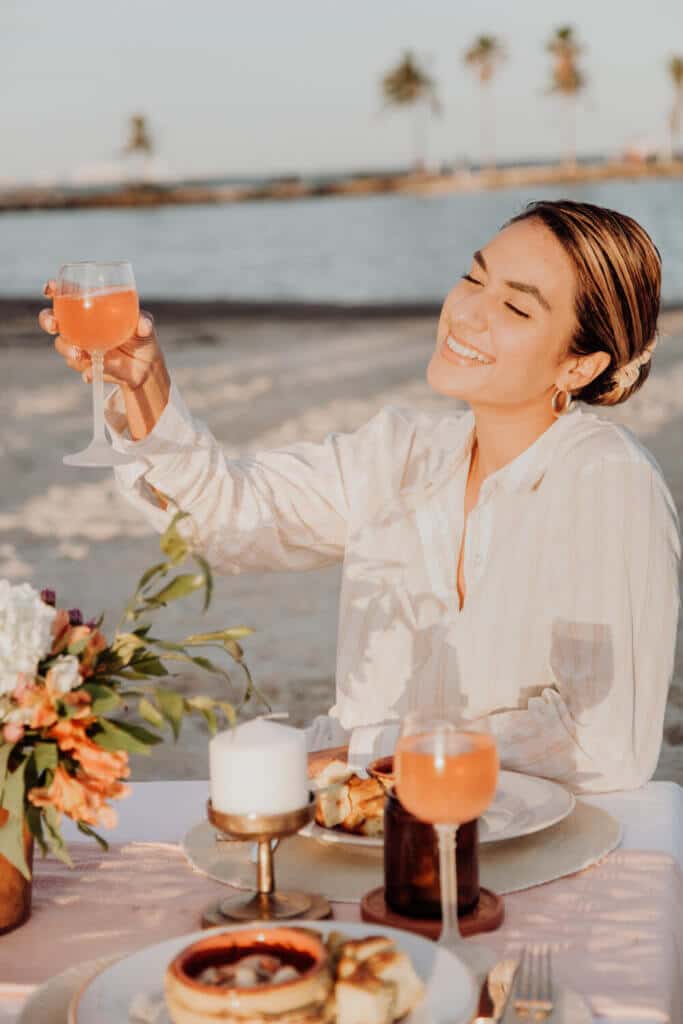 Model raising a glass during commercial photoshoot