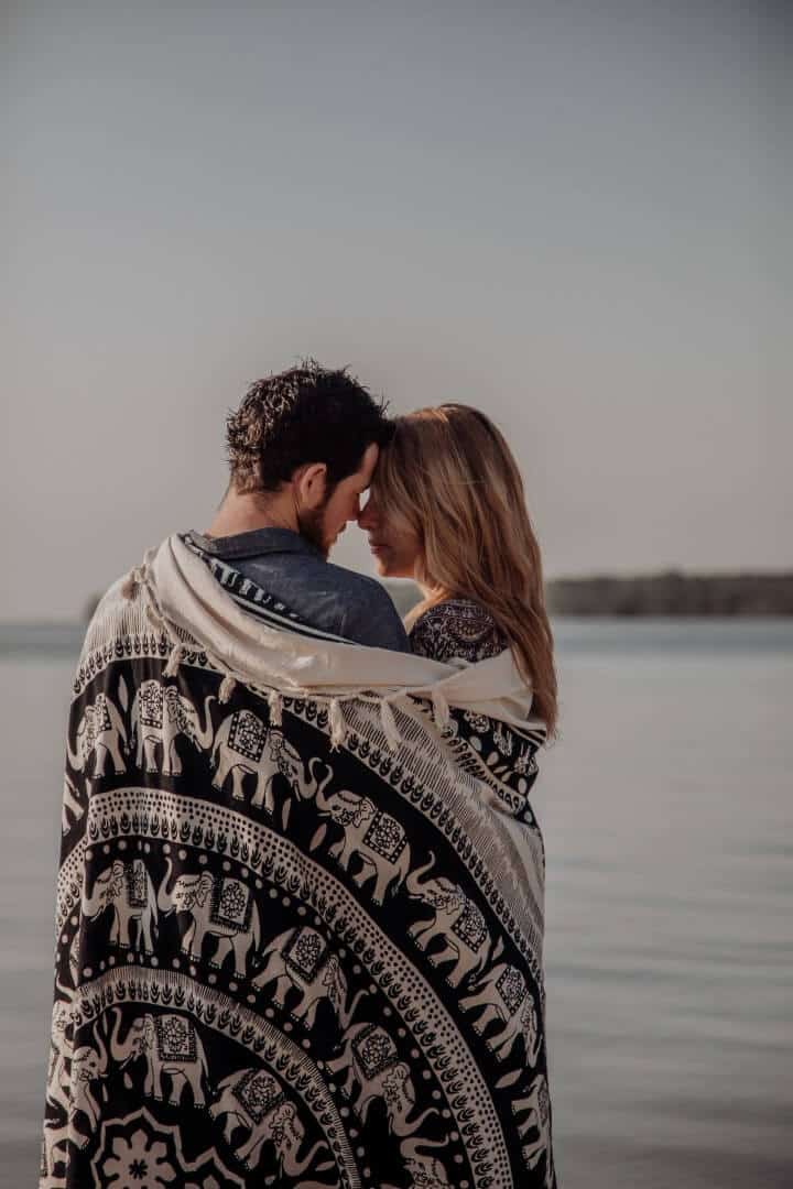 Artistic photo of couple hugging next to the sea