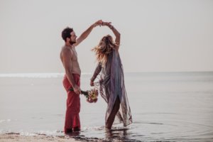 Couple dancing in the water at the beach