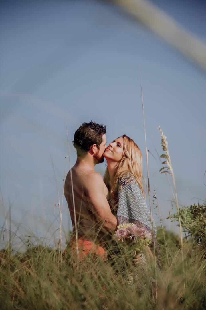 Artistic couple picture kissing in an open forest