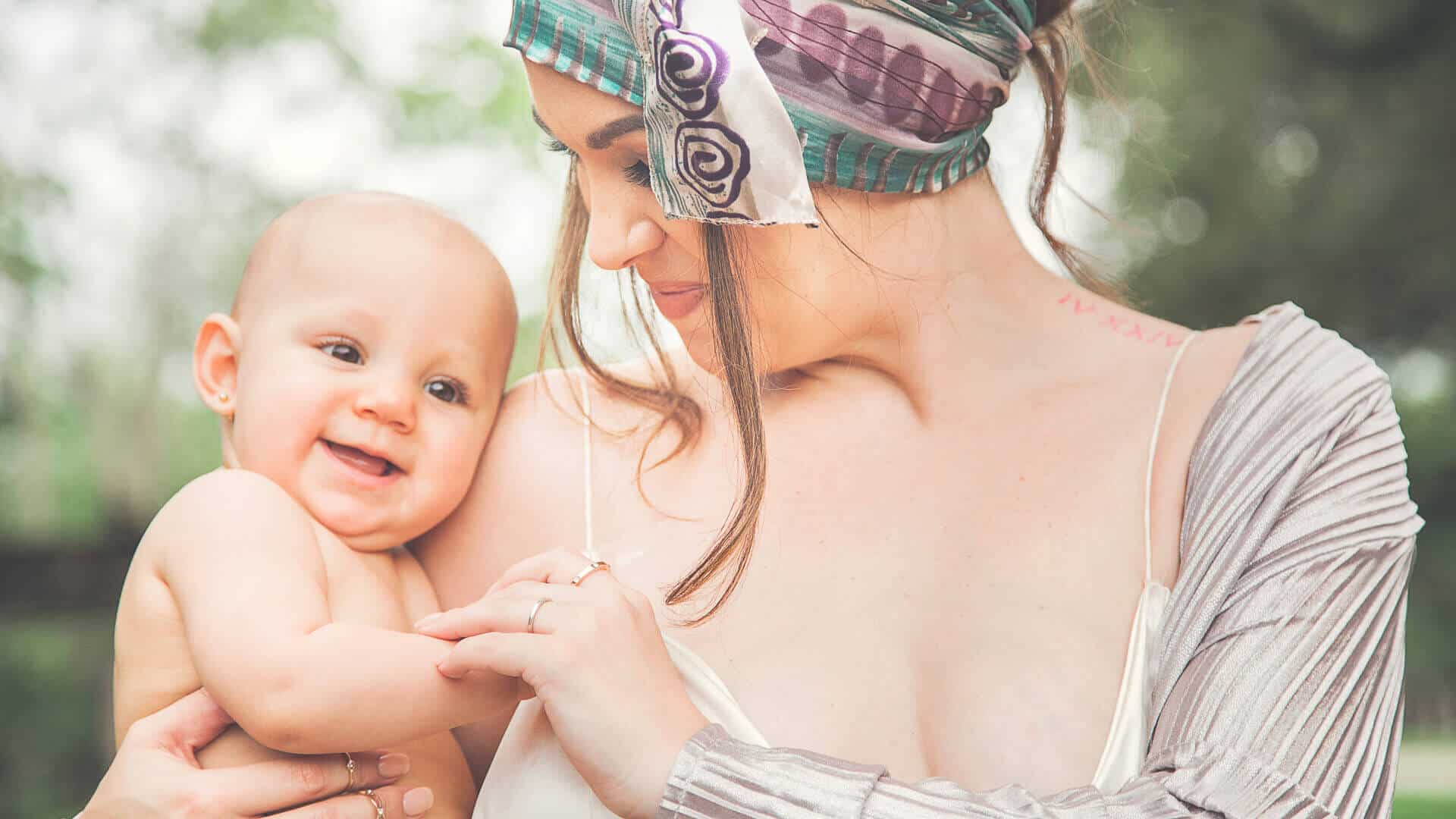 Mother holding her newborn in a very joyous photoshoot