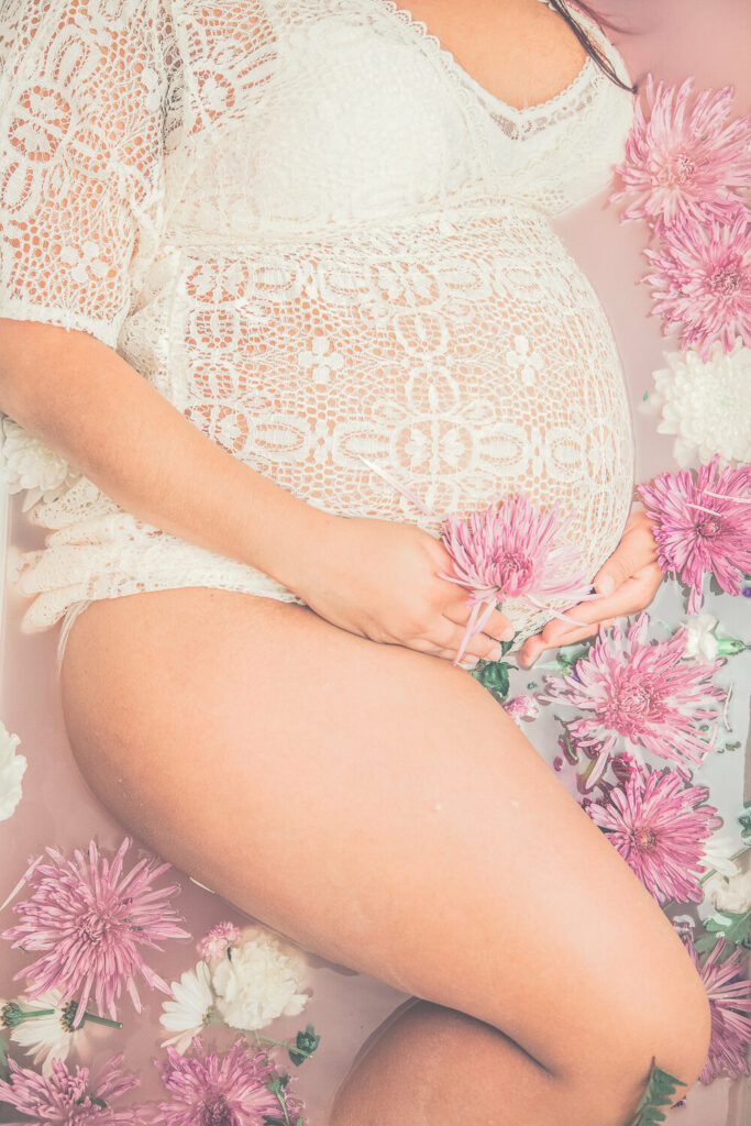 Pregnancy photoshoot idea, milk bath with pink flowers